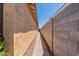 Narrow side yard with a walkway paved with red pavers between the home and block fence at 4332 N 197Th Dr, Litchfield Park, AZ 85340