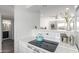 Bright kitchen featuring quartz countertop, electric range, white cabinetry and stainless cocktail shaker at 4610 N 68Th St # 472, Scottsdale, AZ 85251