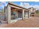 Covered backyard patio with dual ceiling fans and space for outdoor seating at 46175 W Morning View Ln, Maricopa, AZ 85139