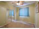 Bedroom with mirrored closet doors, carpet, and a ceiling fan for added comfort at 46175 W Morning View Ln, Maricopa, AZ 85139