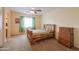 Comfortable bedroom with a rustic wood bed frame and a traditional dresser at 46175 W Morning View Ln, Maricopa, AZ 85139