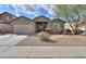 Charming single-story home with desert landscaping, a two-car garage and sunny skies at 46175 W Morning View Ln, Maricopa, AZ 85139