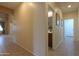 Hallway with tile flooring and a view of the bathroom and other rooms at 46175 W Morning View Ln, Maricopa, AZ 85139