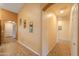 A well-lit hallway with tile flooring and tasteful mirror decorations on the walls at 46175 W Morning View Ln, Maricopa, AZ 85139