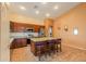 Bright kitchen featuring stainless appliances, granite countertops and tile floors at 46175 W Morning View Ln, Maricopa, AZ 85139