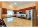 Bright kitchen featuring stainless appliances, granite countertops and tile floors at 46175 W Morning View Ln, Maricopa, AZ 85139