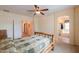 Bright main bedroom with en suite bathroom featuring a soaking tub at 46175 W Morning View Ln, Maricopa, AZ 85139