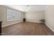 Spacious bedroom with wood-look tile floors, a ceiling fan, and plantation shutters at 4619 E Farmdale Ave, Mesa, AZ 85206