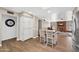 Open floor plan view from kitchen with island, white cabinets, and wood-look floors at 4619 E Farmdale Ave, Mesa, AZ 85206