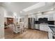 Open kitchen featuring stainless steel appliances, black countertops, and views to the living room at 4619 E Farmdale Ave, Mesa, AZ 85206