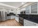 Bright kitchen with stainless appliances, black countertops, and ample white cabinetry at 4619 E Farmdale Ave, Mesa, AZ 85206