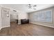 Bright living room with wood-look tile floors, a ceiling fan, and neutral walls at 4619 E Farmdale Ave, Mesa, AZ 85206