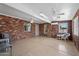 Spacious sunroom with red brick walls, tile flooring, and multiple ceiling fans for comfortable indoor-outdoor living at 4619 E Farmdale Ave, Mesa, AZ 85206