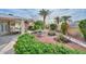 Lush backyard with a beautiful fountain feature, manicured landscaping, and patio area at 5223 W Acoma Dr, Glendale, AZ 85306