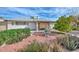 Scenic backyard view with manicured landscaping, decorative fountain and covered patio at 5223 W Acoma Dr, Glendale, AZ 85306