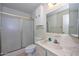 This bathroom features a shower with sliding glass doors and a vanity with a large mirror at 5223 W Acoma Dr, Glendale, AZ 85306