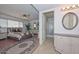 This primary bathroom features an oval mirror, storage cabinet, and access to the main bedroom at 5223 W Acoma Dr, Glendale, AZ 85306