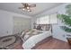 The bedroom includes wood floors, natural lighting, a closet with folding doors and neutral decor at 5223 W Acoma Dr, Glendale, AZ 85306