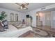 This bedroom features wood floors, a ceiling fan, an ensuite bathroom, and two large mirrors at 5223 W Acoma Dr, Glendale, AZ 85306