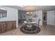 Cozy dining area featuring a decorative chandelier, circular rug, and view to the living room at 5223 W Acoma Dr, Glendale, AZ 85306