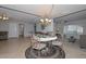 Open dining room area filled with natural light, featuring a round table and ornate chandelier at 5223 W Acoma Dr, Glendale, AZ 85306