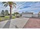 Charming single-story home with a two-car garage, well-maintained landscaping, and a mature palm tree at 5223 W Acoma Dr, Glendale, AZ 85306