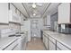 Bright kitchen featuring white appliances, a double ceiling fan and plenty of cabinet and counter space at 5223 W Acoma Dr, Glendale, AZ 85306