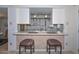 Kitchen view featuring breakfast bar with two stools, white appliances, and an open concept design at 5223 W Acoma Dr, Glendale, AZ 85306