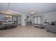 Spacious living room featuring tile floors, ceiling fan, and a seamless transition to the dining area at 5223 W Acoma Dr, Glendale, AZ 85306