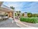 Covered patio with comfortable seating, greenery, and view of a decorative fountain at 5223 W Acoma Dr, Glendale, AZ 85306