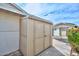 Here is a view of the shed exterior with double doors, a matching house, and clear blue skies at 5223 W Acoma Dr, Glendale, AZ 85306