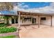 Covered backyard patio with lush greenery, offering a tranquil outdoor space for relaxation at 6036 E Windsor Ave, Scottsdale, AZ 85257