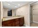 Bathroom with double granite vanity, large mirror, and a walk-in shower at 6036 E Windsor Ave, Scottsdale, AZ 85257