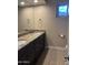 Bathroom featuring granite countertop with double sinks and dark wood cabinets at 6036 E Windsor Ave, Scottsdale, AZ 85257