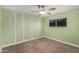 Bright bedroom with creative wall decorations, a ceiling fan, and cozy carpet flooring at 6036 E Windsor Ave, Scottsdale, AZ 85257