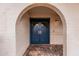 Close up of the double blue front door with an arched entryway and brick pavers at 6036 E Windsor Ave, Scottsdale, AZ 85257