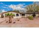 Charming single-story home with desert landscaping, palm tree, and inviting front entrance at 6036 E Windsor Ave, Scottsdale, AZ 85257