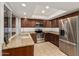 Modern kitchen with granite countertops, stainless steel appliances, and dark wood cabinetry at 6036 E Windsor Ave, Scottsdale, AZ 85257