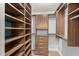 Custom walk-in closet featuring built-in shelves, drawers, and hanging rods for optimal organization and storage at 6036 E Windsor Ave, Scottsdale, AZ 85257