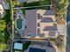 Aerial view showcases pool, putting green, solar panels, and lush backyard at 686 E Vermont Dr, Gilbert, AZ 85295