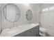 Bright bathroom with dual sinks, granite countertop, and tiled shower at 686 E Vermont Dr, Gilbert, AZ 85295