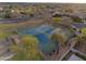 Aerial view of the community tennis courts surrounded by walking paths and mature trees and landscaping at 686 E Vermont Dr, Gilbert, AZ 85295