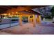 Covered patio featuring brick flooring, a stone fireplace, and string lights for elegant outdoor living at 7216 W Country Gables Dr, Peoria, AZ 85381