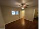 Spacious bedroom with hardwood flooring, a ceiling fan, and ample natural light at 7216 W Country Gables Dr, Peoria, AZ 85381