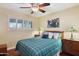 Cozy bedroom with a plush bed, shuttered windows, and stylish lamps at 7216 W Country Gables Dr, Peoria, AZ 85381