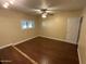 Bright bedroom with hardwood floors, ceiling fan, and a window with natural light at 7216 W Country Gables Dr, Peoria, AZ 85381