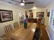 Dining room featuring a wooden table, ceiling fan, and vintage popcorn machine at 7216 W Country Gables Dr, Peoria, AZ 85381