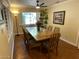 Dining room with hardwood floors, a large table, and bright, natural lighting at 7216 W Country Gables Dr, Peoria, AZ 85381