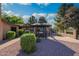 Charming backyard featuring a gazebo with table and chairs, complemented by lush landscaping and beautiful blue skies at 7216 W Country Gables Dr, Peoria, AZ 85381