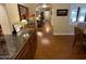 Hallway featuring an arched doorway, wood-look floors, and a granite countertop at 7216 W Country Gables Dr, Peoria, AZ 85381